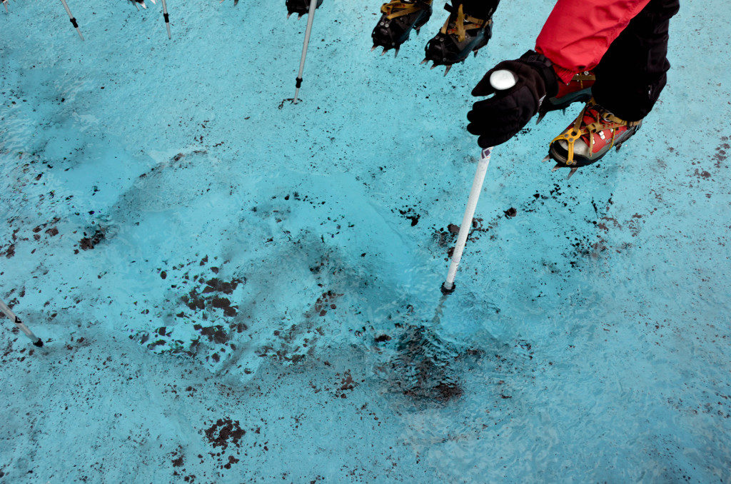 Testing the depth of a puddle on Mendenhall Glacier