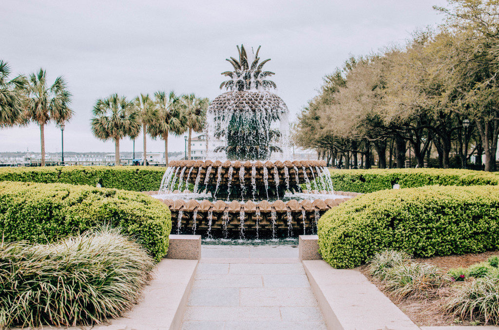 Pineapple-shaped fountain in Charleston surrounded by greenery and trees