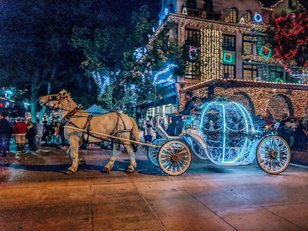 Pumpkin-shaped illuminated carriage pulled by a white horse in Downtown Riverside at the Mission Inn Festival of Lights
