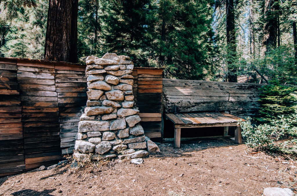 A cabin called Tharp's Log that is a combination of the trunk of a sequoia tree and a typical man-made log cabin