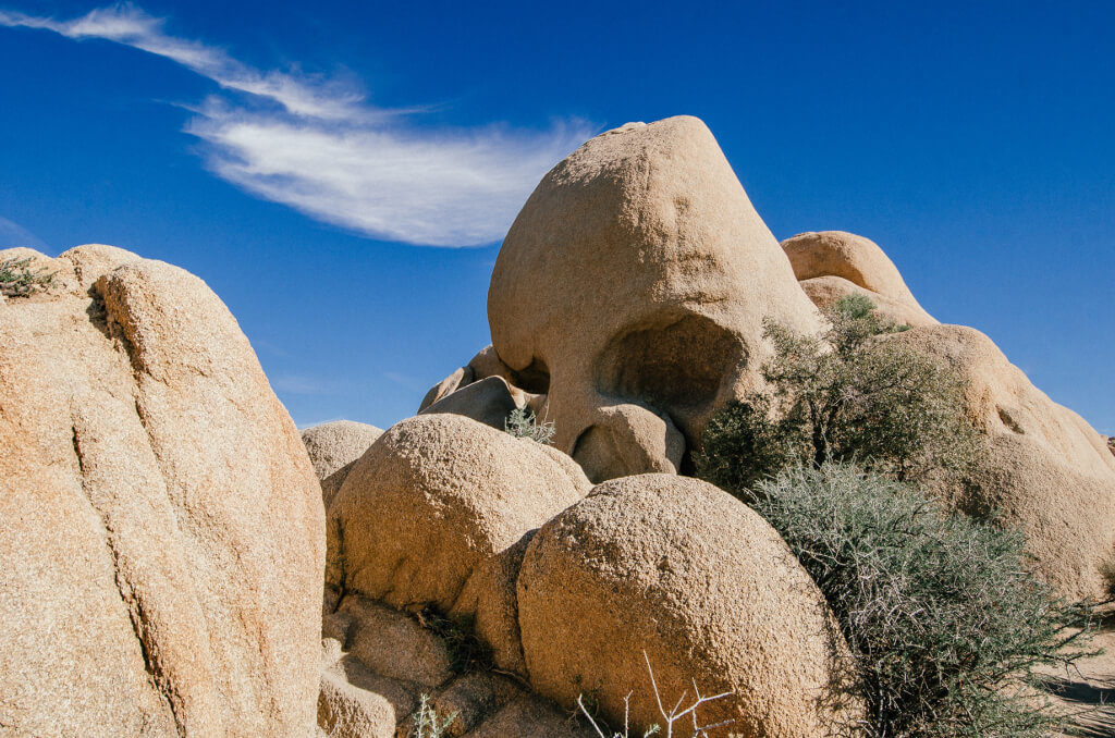 A large rock with two eye sockets and a nose that looks like a skull...now known as Skull Rock, Joshua Tree National Park