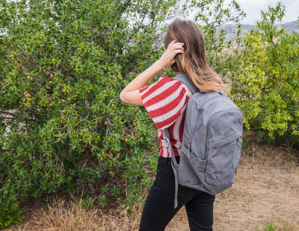 Girl with a gray backpack on her back