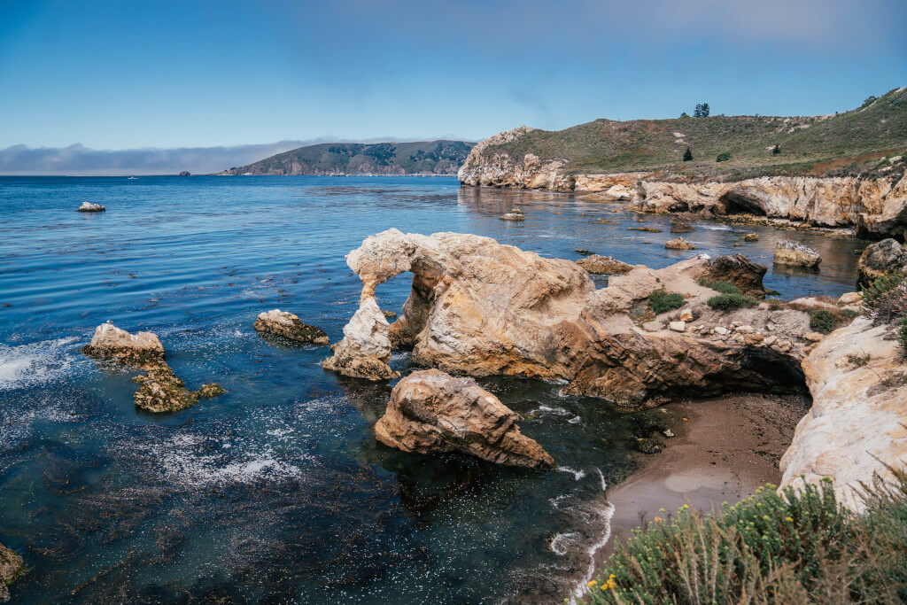 View of the ocean and a rock arch in Avila Beach, California