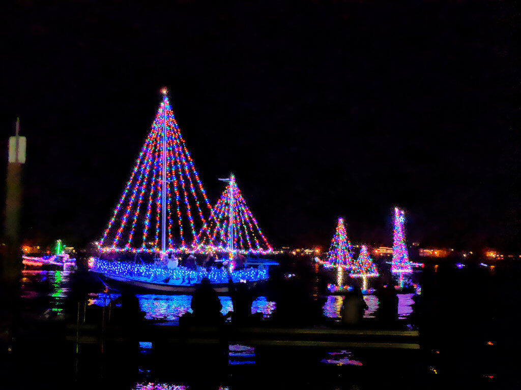 Boats bedecked in Christmas Lights during a parade in the San Diego Bay
