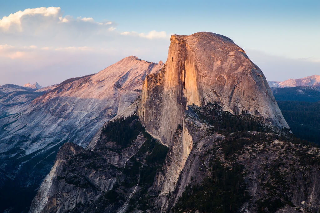 View of Half Dome in Yosemite with soft sunlight on the rock face